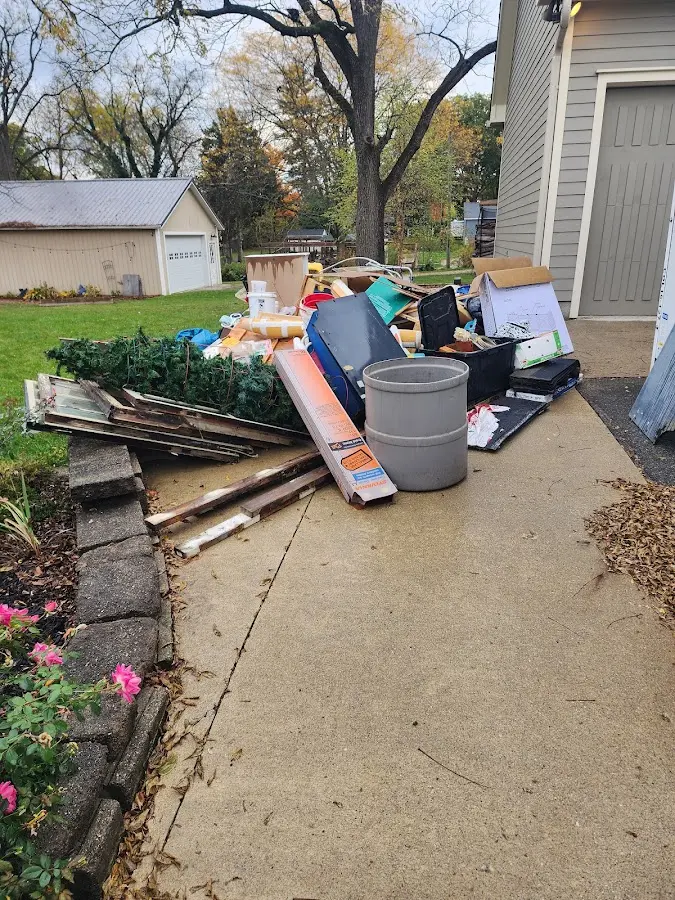 Dumpster being loaded with debris for 12 Yard Dumpster Rental in Great Falls